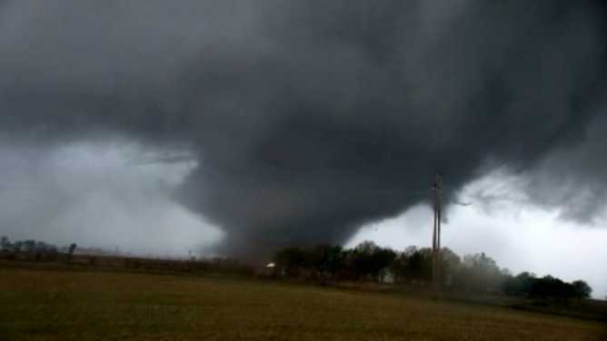 The dark twister leaves damage and debris in it's path in Arkansas.