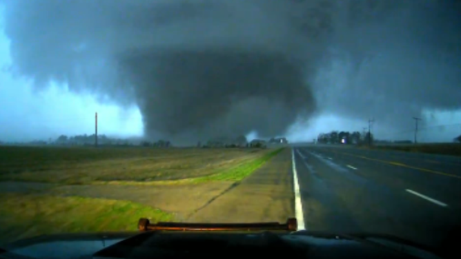 As a tornado touches down in Arkansas, it brings along bright lightning flashes.