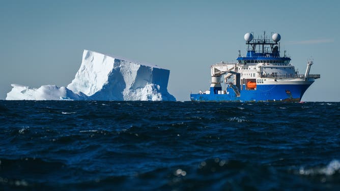 Research Vessel Falkor (too) with the Schmidt Ocean Institute maneuvers around icebergs while conducting research in the Bellingshausen Sea off Antarctica.