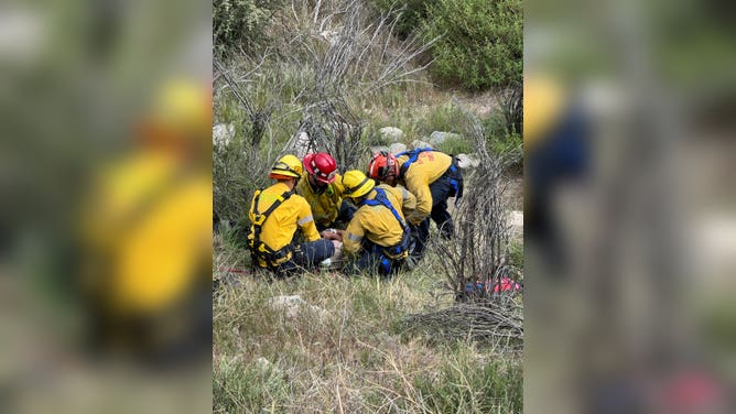 San Bernardino County Fire Protection District crews prepare the crash victim to be safely moved up the mountain.