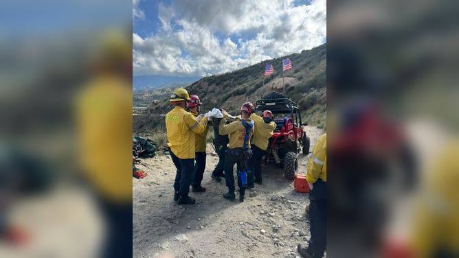 First responders load the crash victim in the All-Terrain Vehicle to be transported for medical assistance.