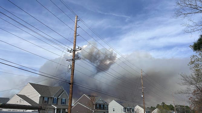 A dark cloud of smoke above homes in Barnegat, New Jersey on April 22, 2025 from the Jones Road Fire.