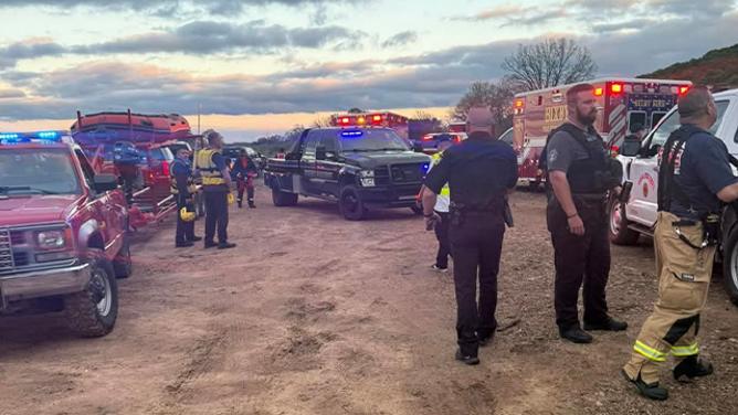 Two people, including a child, are missing after their vehicle was swept away by floodwaters south of Leonard.