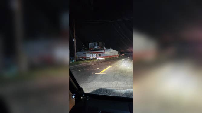 Maplewood Fire Department crew members drive through Delta and observe the damages caused by the large tornado.