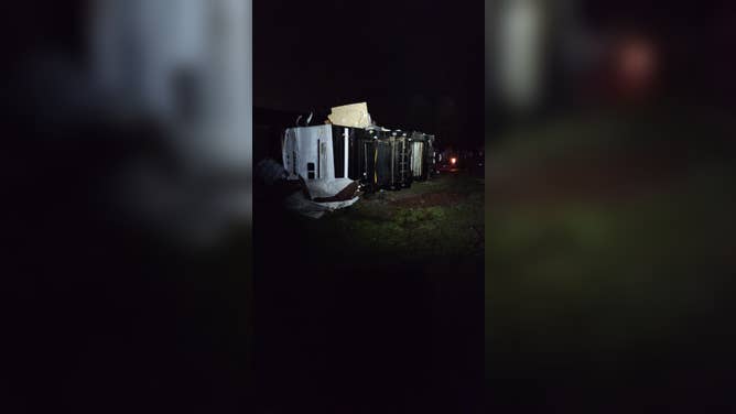 A semi-truck lays on its side after being pushed over by the extreme winds from the large tornado that ripped across the state.