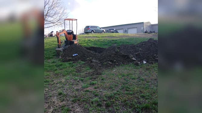 The Temu excavator digging the hole for the van.