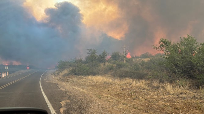 Thick black smoke blocks the sky in Pinal County, Az. The Cody Fire has burned 1,000 acres, prompting evacuations. 
