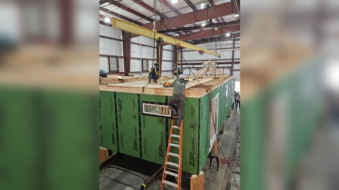 High school students building Sherry Housley's tiny home.