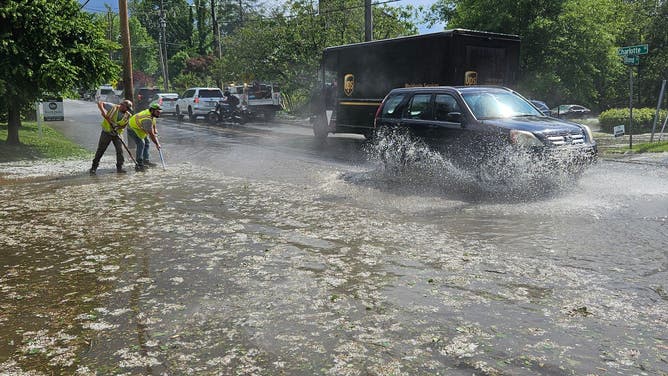 Crews in Asheville, NC clean up after hail and torrential downpours Thursday, May 8, 2025.