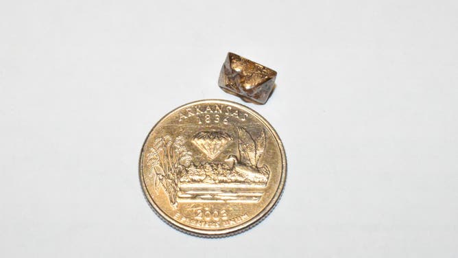 The Duke Diamond next to a quarter for scale.