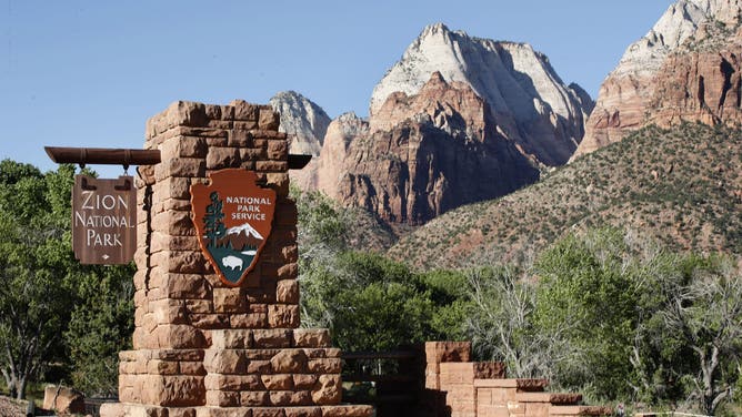 SPRINGDALE, UT - MAY 14: A sign hangs at the entrance to Zion National Park on May 14, 2020 in Springdale, Utah. Zion National Park had a limited reopening yesterday as part of its reopening plan after it was closed due to the COVID-19 pandemic.