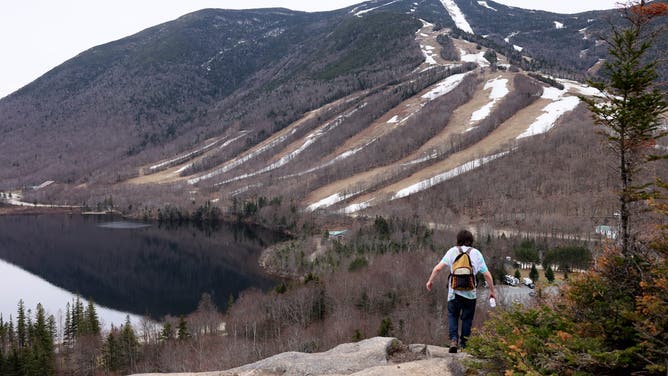 April 28: A hiker made his way along the rocks at Artists Bluff in New Hampshires White Mountains in Franconia, NH on April 28, 2021.