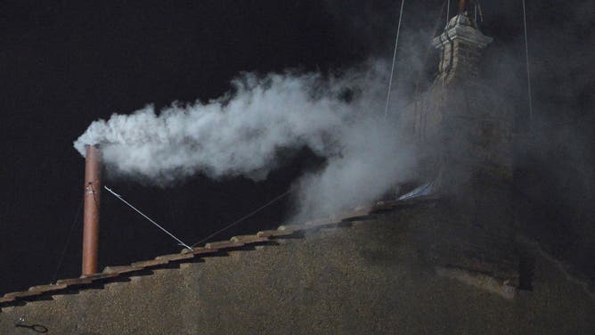 White smoke rises from the chimney on the roof of the Sistine Chapel meaning that cardinals elected a new pope on the second day of their secret conclave on March 13, 2013 at the Vatican.