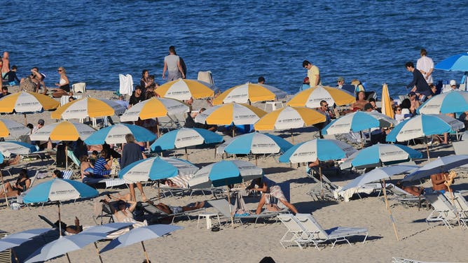 MIAMI BEACH - JANUARY 01: Visitors enjoy the sun and surf on January 01, 2024 in Miami Beach, Florida, United States. The warm climate and the beautiful sand beaches draws tourists to Miami throughout the year.