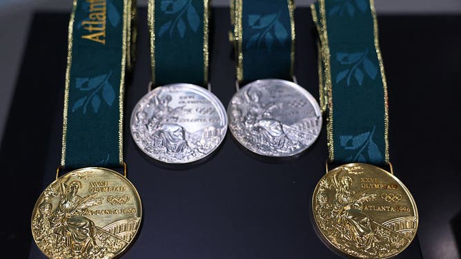 A picture taken at the Olympic House in Lausanne on May 5, 2025 shows the replica Olympic medals from Atlanta 1996 ahead of their handover ceremony to American swimmer Gary Hall Jr. after the originals were destroyed with his house in the Los Angeles wildfires earlier this year.