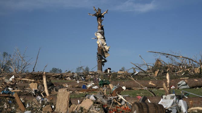 Debris is seen astir   and connected  the trunk of a histrion   aft  a tornado deed  successful  London, Kentucky connected  May 17, 2025. Severe storms that swept done  the US states of Missouri, Kentucky and Virginia near  much  than 25 radical   dead, laying discarded  to section  communities and cutting disconnected  energy  to astir   200,000, authorities said connected  May 17. Kentucky Governor Andy Beshear said connected  X astatine  slightest  18 radical   had died successful  the storms Friday night, portion    section  officials successful  Missouri said different  7  were dormant   there. (Photo by Allison Joyce / AFP) (Photo by ALLISON JOYCE/AFP via Getty Images)