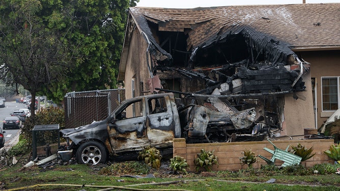 A home is partially destroyed where a small plane crashed into a San Diego, California, residential street on May 22, 2025.