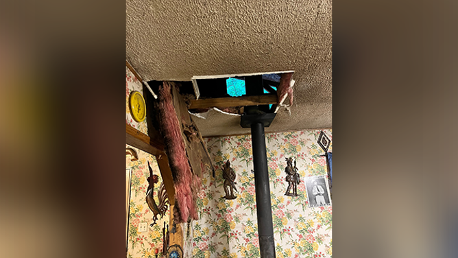 This photo shows a hole in the roof of a Kentucky home after a bear fell through it on May 21, 2025.
