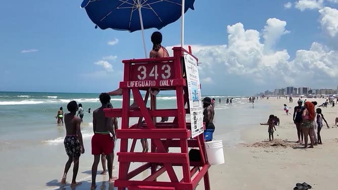 A lifeguard watches beachgoers on Daytona Beach. 