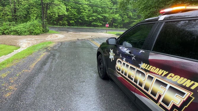 Rushing water blocks a road in Allegany County, Maryland, on May 13, 2025.