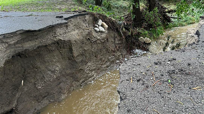 This photo shows a road that was washed away in Skiatook, Oklahoma, after severe weather and torrential rain on Saturday, May 24, 2025.
