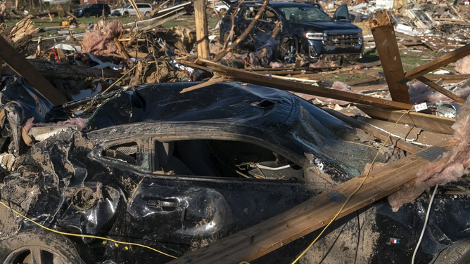 Debris is seen on a damaged car after a tornado hit in London, Kentucky on May 17, 2025. Severe storms that swept through the US states of Missouri, Kentucky and Virginia left more than 25 people dead, laying waste to local communities and cutting off electricity to nearly 200,000, authorities said on May 17. Kentucky Governor Andy Beshear said on X at least 18 people had died in the storms Friday night, while local officials in Missouri said another seven were dead there. (Photo by Allison Joyce / AFP) (Photo by ALLISON JOYCE/AFP via Getty Images)