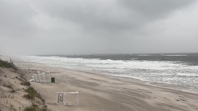This image shows waves crashing and sand blasting across the beach as a nor'easter slams the Northeast on May 22, 2025.
