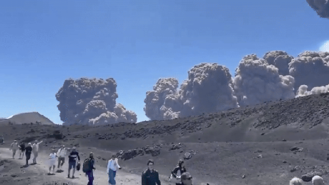 This animated image shows people running for safety after Italy's Mount Etna volcano violently erupted on Monday, June 2, 2025.