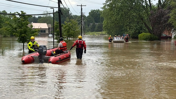 Crews respond to people stuck in flooding.
