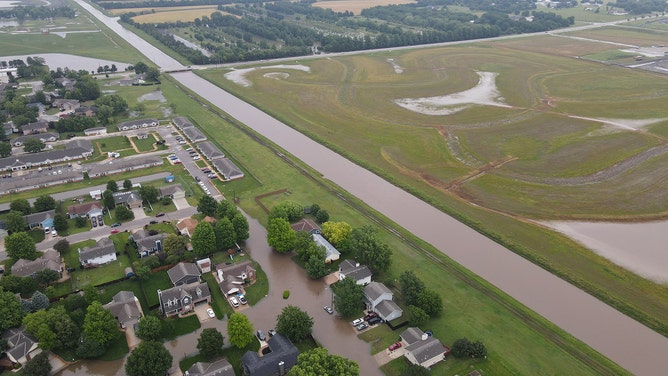 Drone footage reveals the devastating extent of flash flooding that swallowed homes and roads in Valley Center, Kansas, on Tuesday.