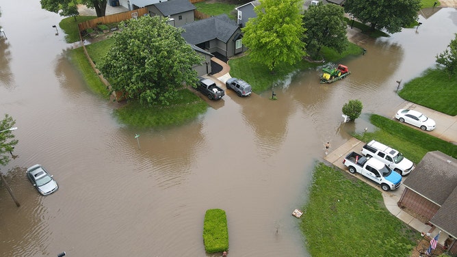 Drone footage reveals the devastating extent of flash flooding that swallowed homes and roads in Valley Center, Kansas, on Tuesday.