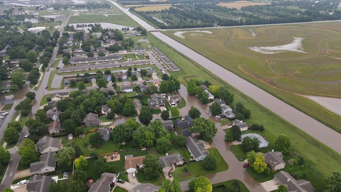 Drone footage reveals the devastating extent of flash flooding that swallowed homes and roads in Valley Center, Kansas, on Tuesday.