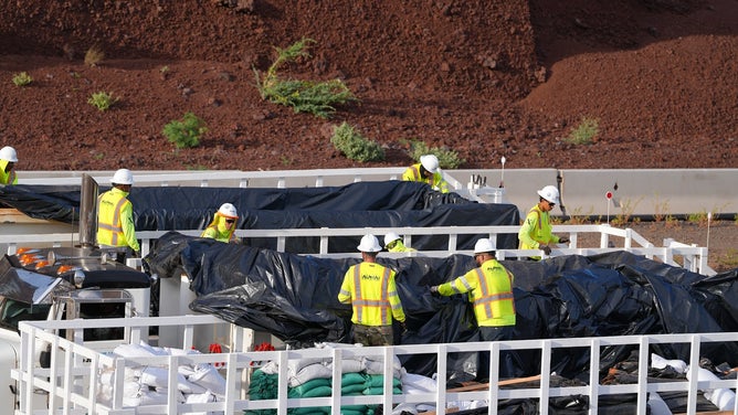Dump trucks moving Lahaina wildfire debris on Monday, June 15, 2025.