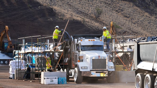 Dump trucks moving Lahaina wildfire debris on Monday, June 15, 2025.