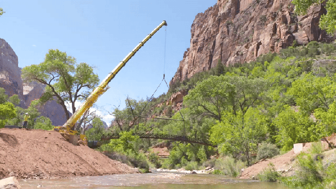 Looped video of crane moving Emerald Pools bridge to new location.