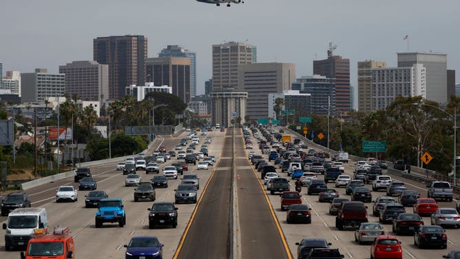 FILE - SAN DIEGO, CALIFORNIA - JUNE 28: An Alaska Airlines SkyWest Embraer E175LR aircraft approaches San Diego International Airport for a landing from San Luis Obispo as traffic on southbound Interstate 5 slows during the afternoon commute heading into downtown San Diego on June 28, 2024 in San Diego, California. (Photo by Kevin Carter/Getty Images)
