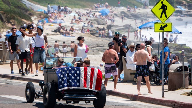 FILE - SAN DIEGO, CALIFORNIA -JULY 4: People celebrate the 4th of July along the La Jolla coast on a hot summer day on July 4, 2023 in San Diego, California. San Diego is a top destination for summer travel. (Photo by Kevin Carter/Getty Images)
