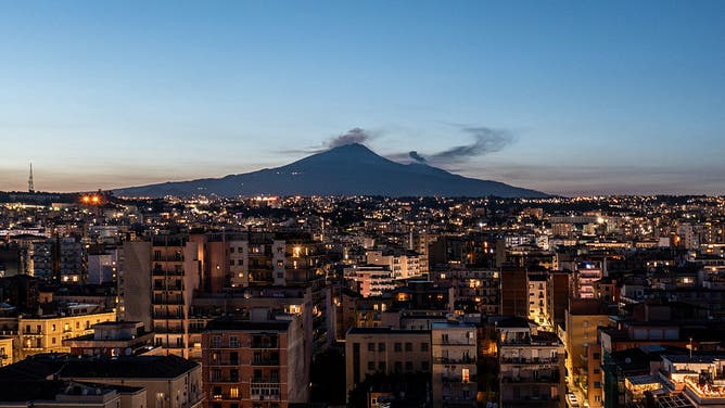 Mount Etna at sunset, seen from downtown Catania, appears calm after this morning’s violent eruption that destroyed the southeastern crater wall, sending plumes of volcanic steam and ash into the sky on June 02, 2025 in Catania, Italy.