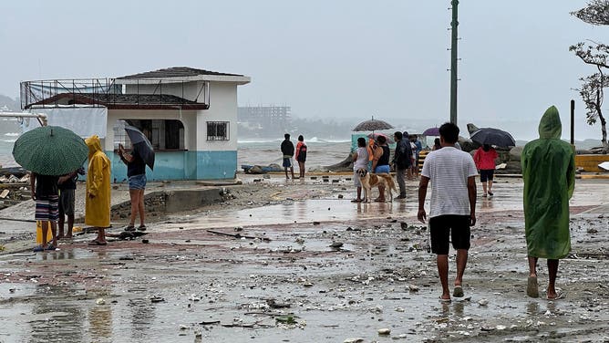 Locals look at damages following the passage of Hurricane Erick in Bahia Principal, Puerto Escondido, state of Oaxaca, Mexico, on June 19, 2025. Erick, a category 4 hurricane on a scale of 5, made landfall in the Mexican state of Oaxaca (west) on the Pacific coast, the United States National Hurricane Center (NHC) reported. (Photo by CARLO ECHEGOYEN / AFP) (Photo by CARLO ECHEGOYEN/AFP via Getty Images)
