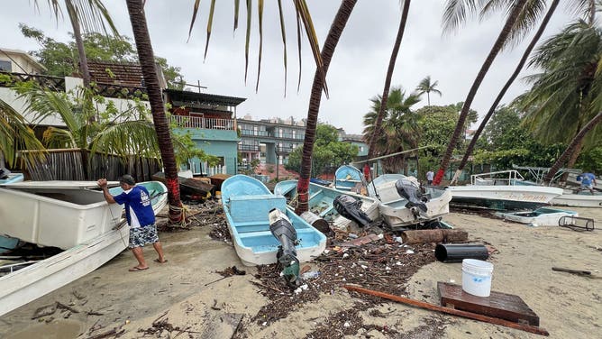 A man checks damages following the passage of Hurricane Erick in Bahia Principal, Puerto Escondido, state of Oaxaca, Mexico, on June 19, 2025. Erick, a category 4 hurricane on a scale of 5, made landfall in the Mexican state of Oaxaca (west) on the Pacific coast, the United States National Hurricane Center (NHC) reported. (Photo by CARLO ECHEGOYEN / AFP) (Photo by CARLO ECHEGOYEN/AFP via Getty Images)