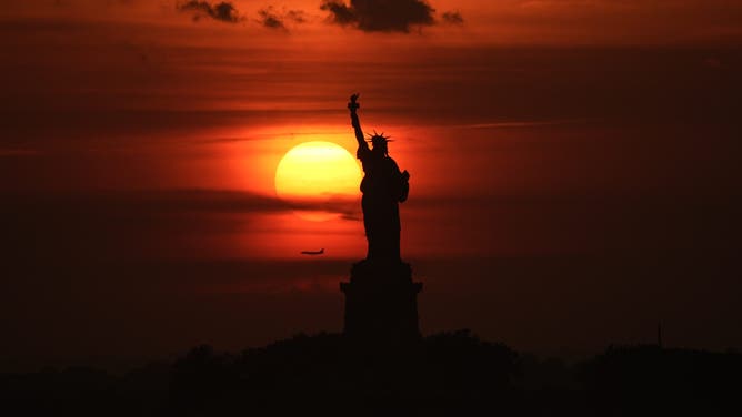 NEW YORK, NY - JUNE 23: A view of the Statue of Liberty seen from New Jersey, United States as a dangerous heat wave sweeps across the region on June 23, 2025.New York City activated its Heat Emergency Plan for the first time in 2025, while Governor Kathy Hochul declared a state of emergency for 32 counties, including all five boroughs. (Photo by Lokman Vural Elibol/Anadolu via Getty Images)