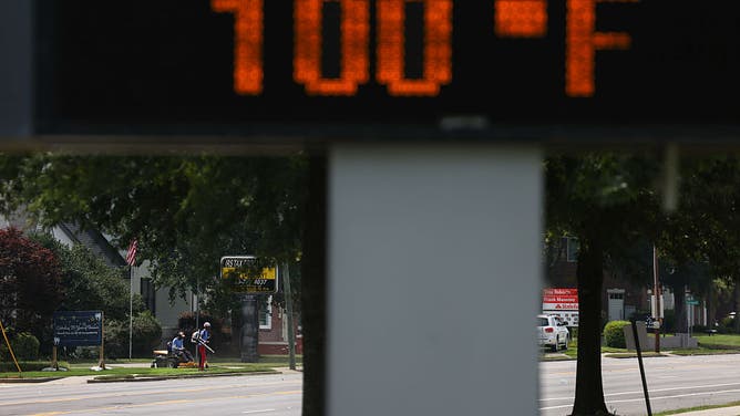 A thermometer reading 100 degrees outside a high school during high temperatures in Columbia, South Carolina, US, on Tuesday, June 24, 2025. dangerous heat dome scorches millions