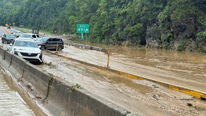 Abandoned cars sit in a section of I-40 in the Blue Ridge Mountains where mudslides and flooding closed a part of the highway.