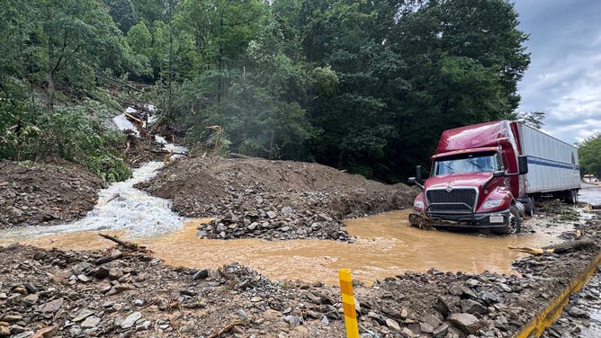 Mud and rocks sit on I-40 at the Tennessee/North Carolina border after flash flooding and landslides closed the road.