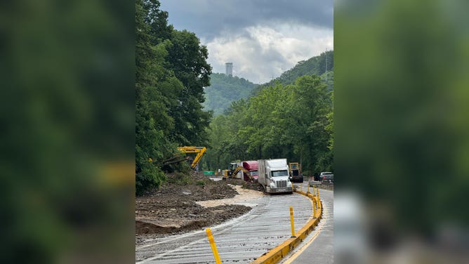 Road crews work hard to clear I-40 of flooding and debris.