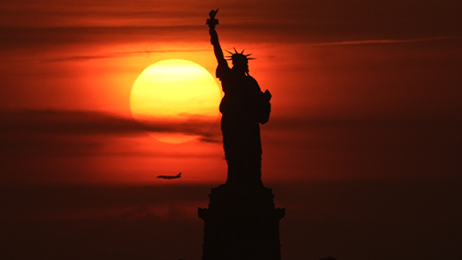 NEW YORK, NY - JUNE 23: A view of the Statue of Liberty seen from New Jersey, United States as a dangerous heat wave sweeps across the region on June 23, 2025.New York City activated its Heat Emergency Plan for the first time in 2025, while Governor Kathy Hochul declared a state of emergency for 32 counties, including all five boroughs. (Photo by Lokman Vural Elibol/Anadolu via Getty Images)