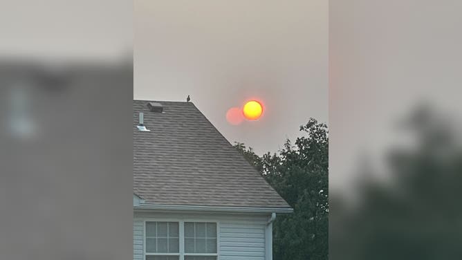 Canadian wildfire smoke turns sunset orange-red in O'Fallon, Illinois on Sunday, June 1, 2025.