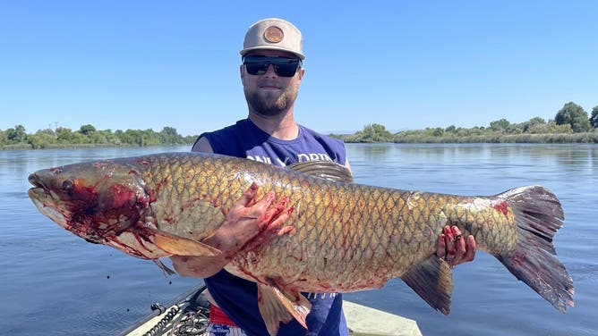 Riley Farden holds his record-breaking catch.