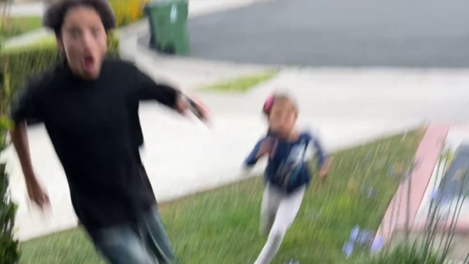 Kids run inside away from lightning strike