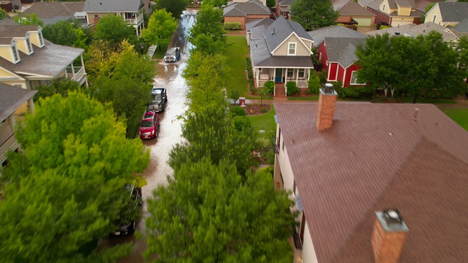 Homes appear to be unaffected by flooded streets in a neighborhood in Lubbock.